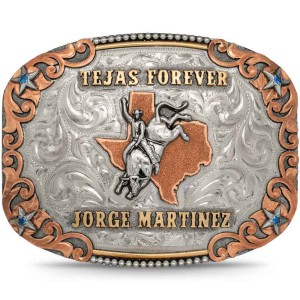 A custom bull riding belt buckle trophy featuring a bull rider silver figure and bronze lettering that says Tejas Forever 