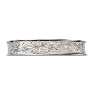 A silver cuff bracelet for men and women featuring a hand engraved floral pattern