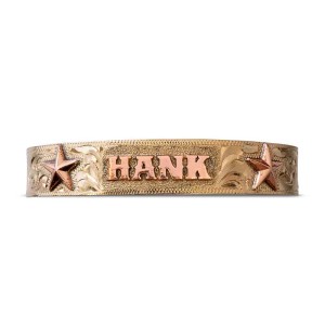 A golden cuff bracelet for men and women featuring golden star figures and personalized copper lettering 