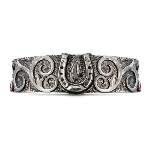 A silver cuff bracelet for men and women featuring a western horseshoe figure 