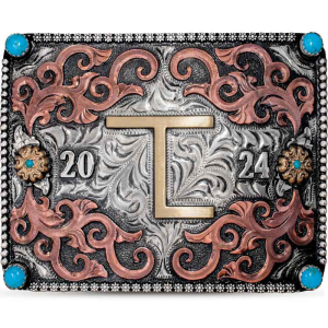 A custom initials belt buckle with copper scrolls on a hand engraved silver base with simulated turquoise stones featuring a golden bronze ranch brand figure