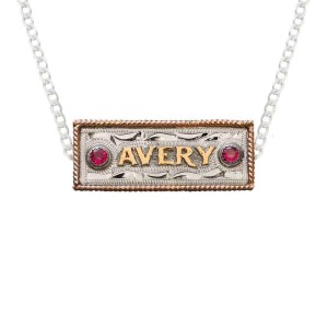 A custom name plate pendant necklace featuring personalized bronze lettering, with a sterling silver chain