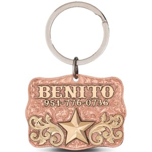 A custom dog tag with personalized engraved bronze lettering built on a copper base, featuring a gold star, western designed