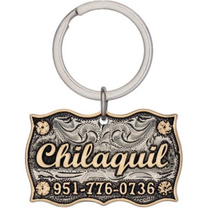 A custom dog tag with personalized engraved bronze lettering built on a silver matted base, western designed 