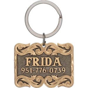 A custom dog tag with personalized engraved bronze lettering built on a silver matted base, western designed 