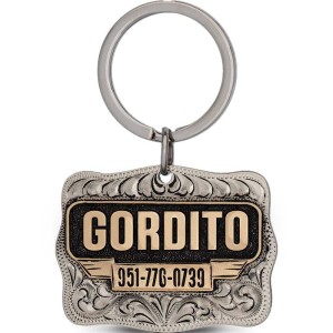 A custom dog tag with personalized engraved bronze lettering built on a silver antiqued base, western designed 