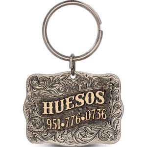 A custom dog tag with personalized engraved bronze lettering built on a silver base, western designed 