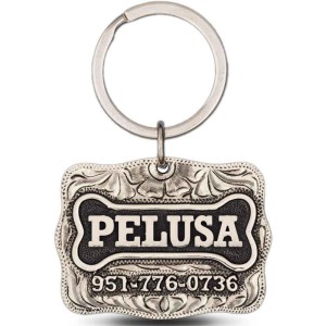 A custom dog tag with personalized engraved silver lettering, built on a silver base, featuring a bone figure, western designed 