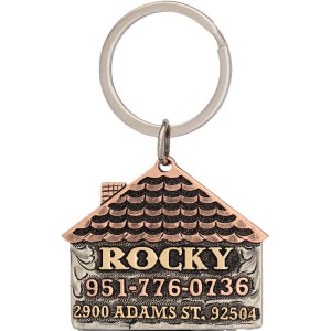 A custom dog tag with personalized engraved bronze lettering built on a silver home-shaped base, western designed 