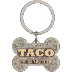 A custom dog tag with personalized engraved bronze lettering built on a bone-shaped silver base, western designed 