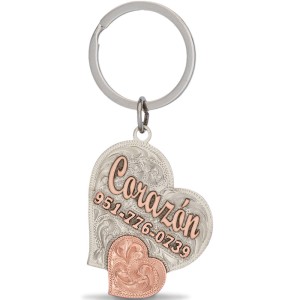 A  custom dog tag with personalized engraved copper lettering built on a heart-shaped silver base, featuring a copper heart figure, western designed