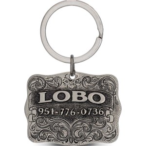 A custom dog tag with personalized engraved silver lettering built on a german silver antiqued and matted base, western designed 