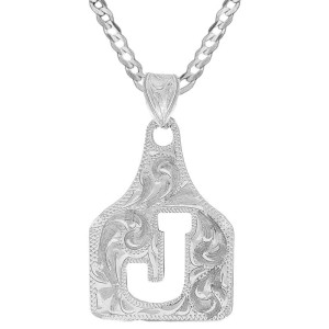 A custom cow tag pendant necklace built on a hand engraved silver base with an initial 