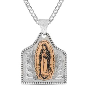 A custom cow tag pendant necklace built on a hand engraved silver base with a Virgen de Guadalupe figure in the center