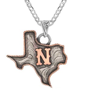 A custom pendant necklace built on a hand engraved silver base in the shape of Texas State with a copper initial in the center